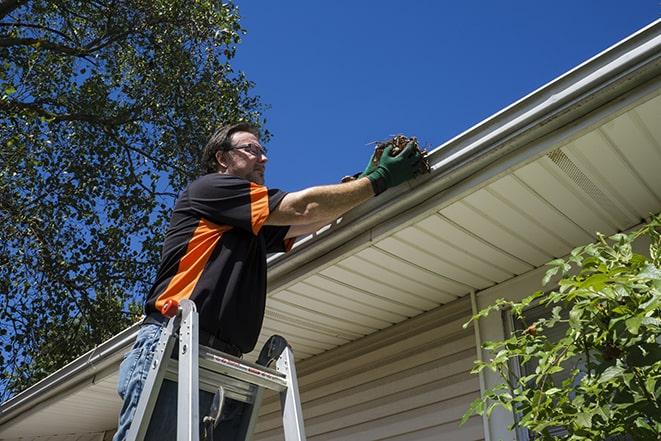 home renovation worker replacing broken gutter sections in Allison Park PA